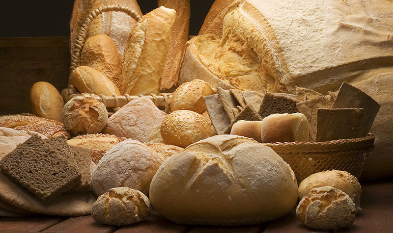 table decorated with various artisan breads