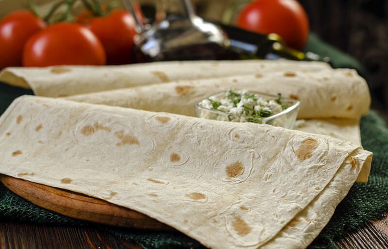 Armenian thin lavash and cottage cheese with herbs, lavash sheets close-up