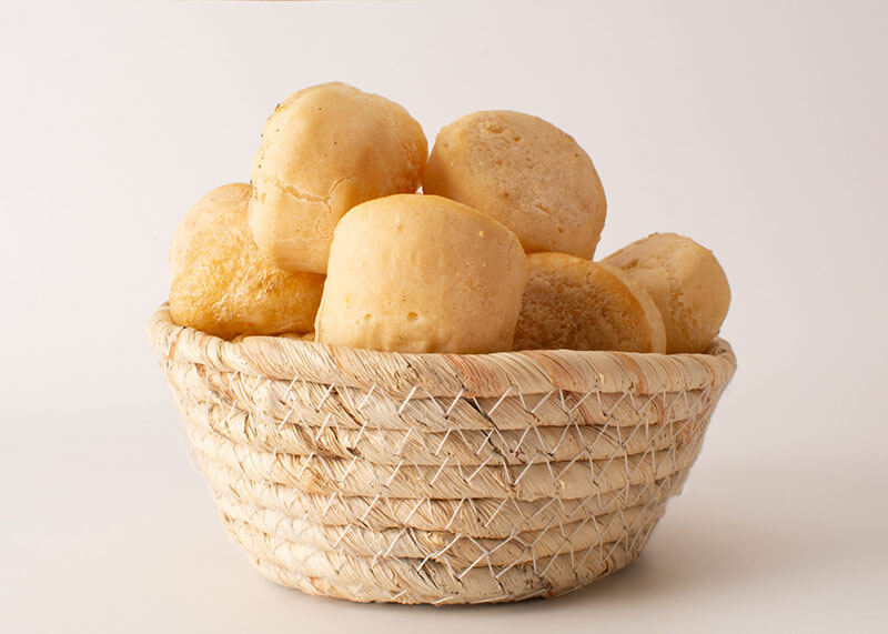 Minas Gerais cheese bread, hot, a portion on a basket, white background, focused, isolated